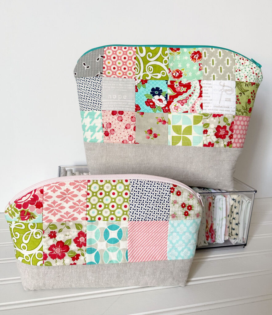 The Carly pouch in two sizes with the large sitting on the fabric box